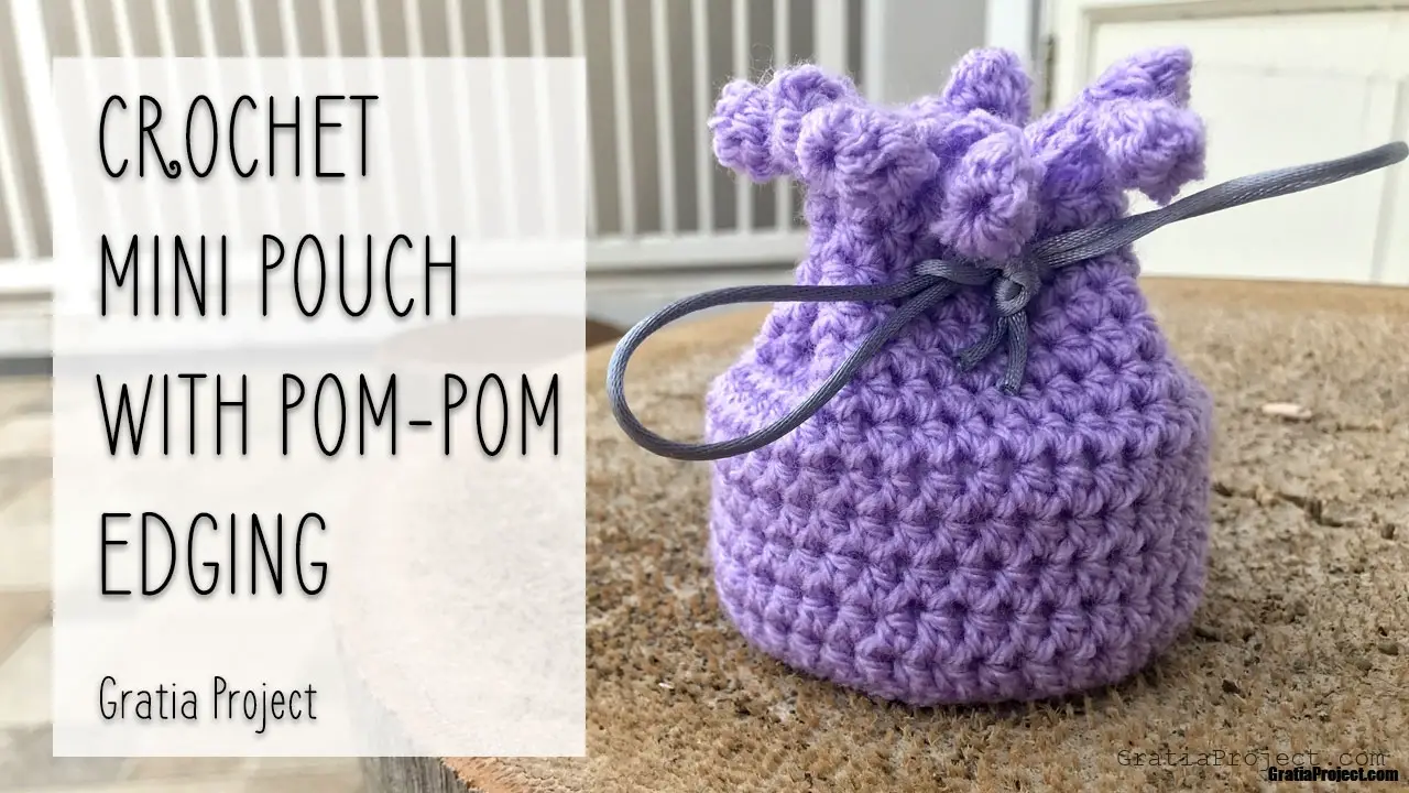 crochet mini pouch with pom-pom edging